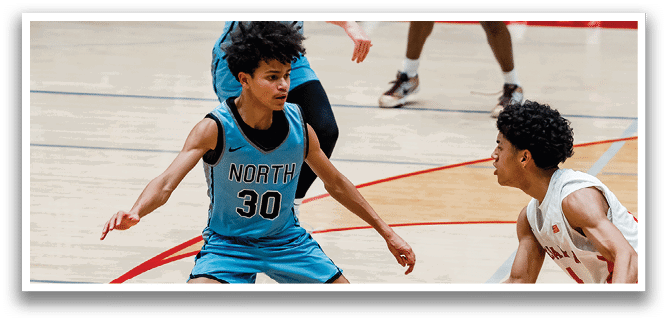 Two basketball players are playing on a court, one wearing a blue shirt and the other wearing a red shirt. They are both trying to gain possession of the basketball. AI generated content