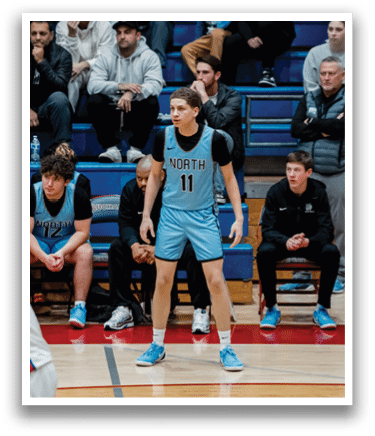 A basketball player stands on the court wearing a blue uniform. AI generated content