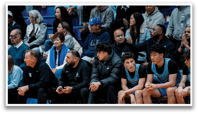 A group of people are sitting on a bench, watching a basketball game. AI generated content