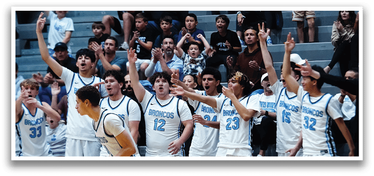 A group of men are playing basketball, with one man running towards the basket while others cheer him on. AI generated content