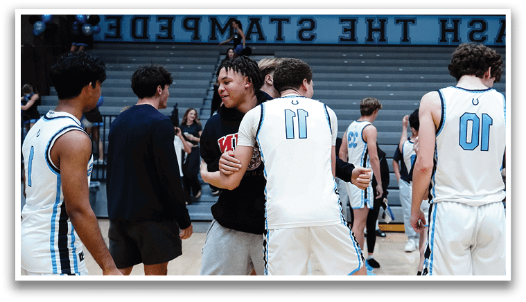 A group of men wearing blue uniforms are standing on a basketball court, engaged in a conversation. AI generated content