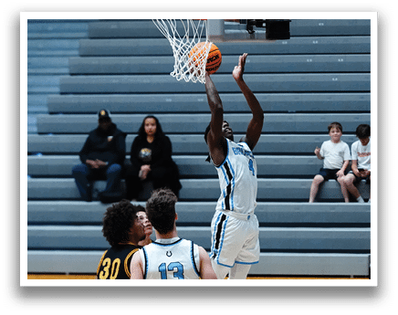 A basketball player leaps to block a shot, while a referee looks on. AI generated content