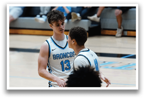 Two men wearing basketball uniforms are talking to each other on a basketball court. AI generated content