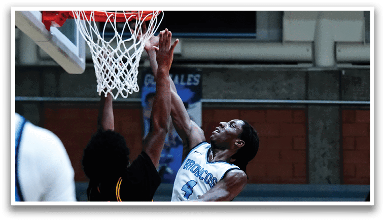 A group of people are sitting in the stands, watching a game. They are wearing various clothing, including hoodies and hats. Some of the people are wearing glasses. The crowd is engaged in the event and appears to be enjoying the game. AI generated content