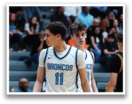 A group of young men playing basketball, with one player wearing a blue and white jersey with the number 11. AI generated content