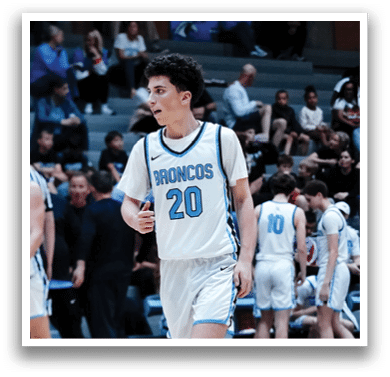 A basketball player wearing a blue and white uniform with the number 20 on the back walks onto the court. AI generated content