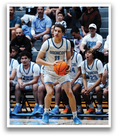 A basketball player is holding a basketball while standing in front of a group of other players. AI generated content