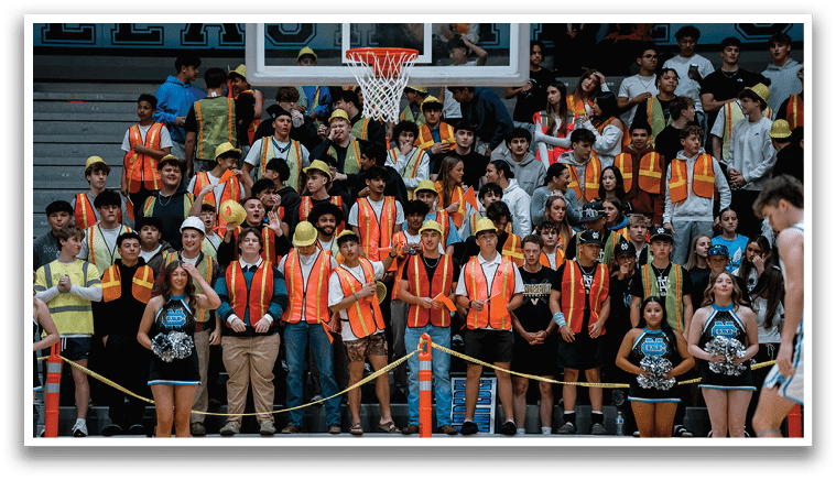 A group of people wearing orange vests are standing in front of a basketball court. AI generated content