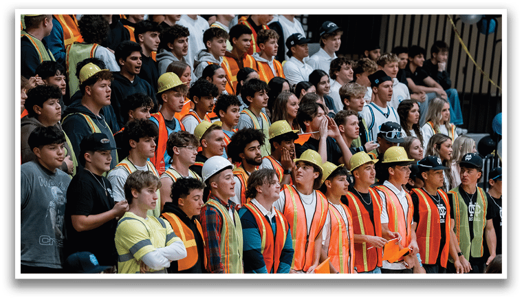 A group of construction workers wearing orange vests stand in front of a crowd of people. AI generated content