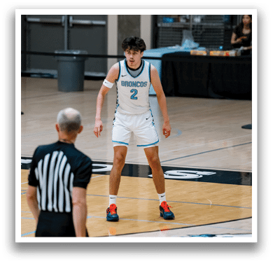 A basketball player wearing a blue jersey with the number 2 on it is standing on the court. AI generated content