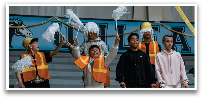 A group of young people are standing in a gym, holding pom poms. AI generated content