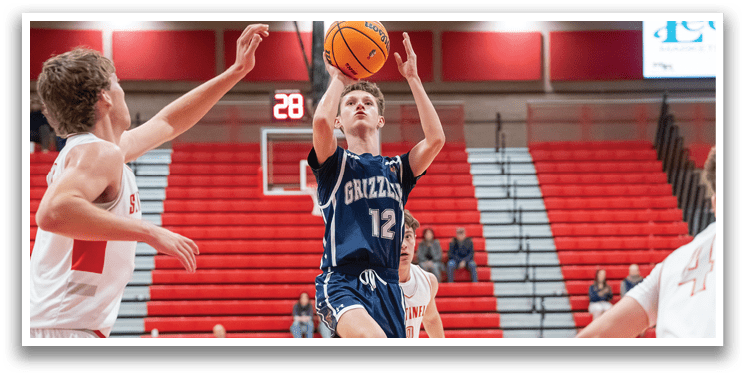 A basketball player in a blue uniform is attempting to shoot the ball while being guarded by another player. AI generated content