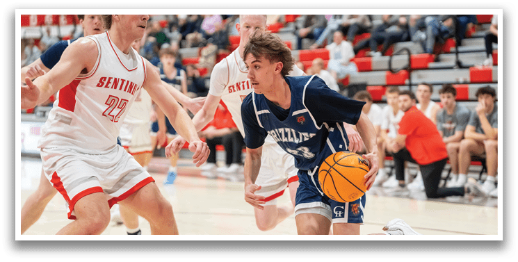A basketball player in a blue uniform is running with the ball, while other players try to defend him. AI generated content