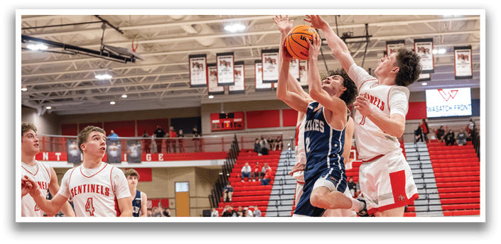 A group of young men playing basketball on a court. One player is jumping up to grab the ball while others look on. AI generated content