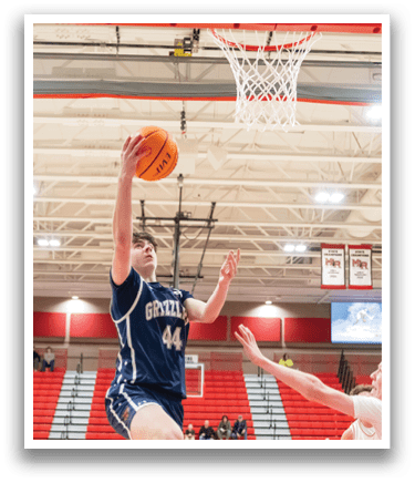 Two basketball players are playing in a gym. One player is jumping to shoot the ball, while the other player is trying to block the shot. AI generated content