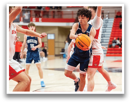 A basketball player in a blue uniform is holding a yellow ball while two other players try to block him. AI generated content
