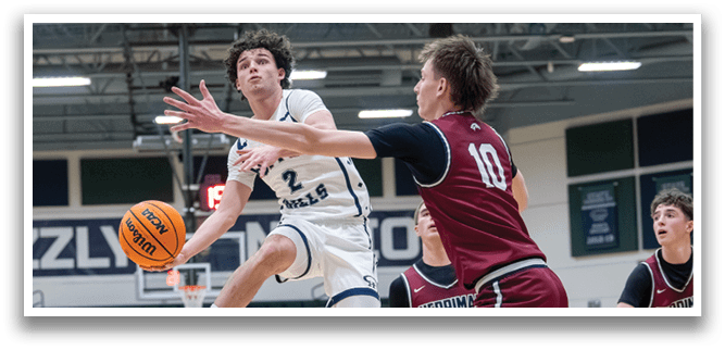 Two basketball players are in the middle of a game, one is jumping to grab the ball while the other tries to block him. AI generated content