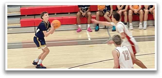 A group of young men playing basketball on a court. AI generated content