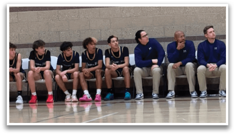 A group of young men are sitting on a bench in a gym. AI generated content