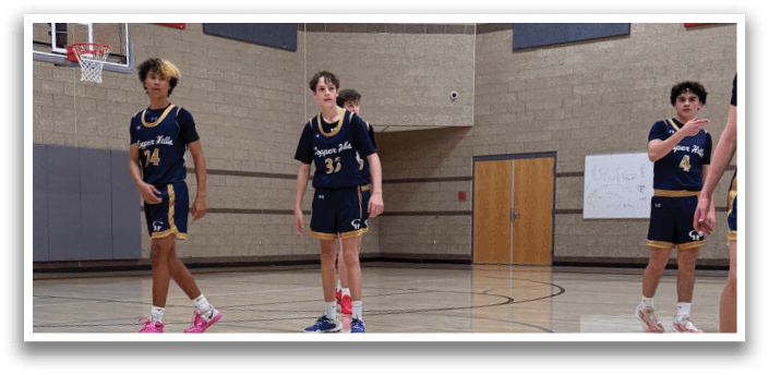 A group of young men playing basketball in a gym. AI generated content
