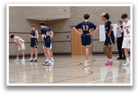 A group of young men are standing on a basketball court, wearing uniforms and waiting for the game to start. AI generated content
