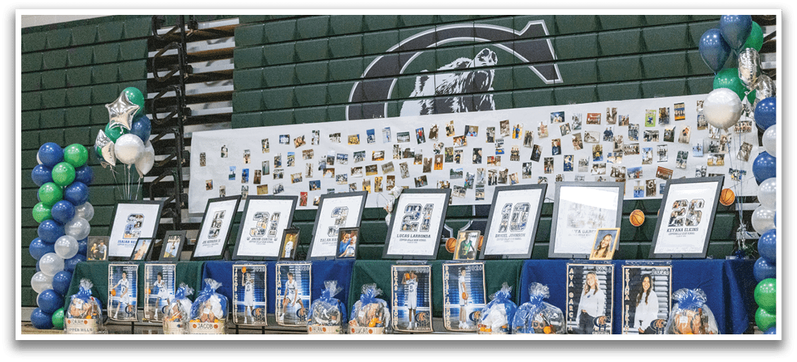 A display of photos and memorabilia is set up on a basketball court. AI generated content