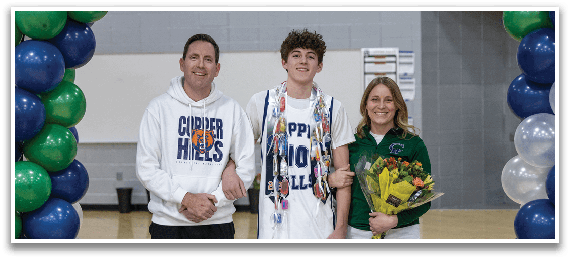 A man, woman, and boy stand together on a basketball court, posing for a photo. The boy is wearing a basketball uniform and holding a bouquet of flowers. AI generated content