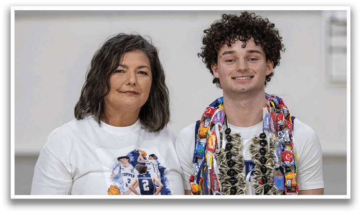 A man and a woman are standing next to each other, both wearing necklaces. The man is wearing a lei around his neck. AI generated content