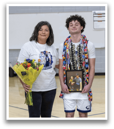 A man and woman stand on a basketball court, the man holding a trophy. AI generated content