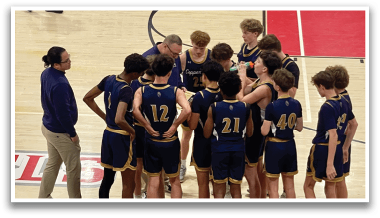 A group of young men wearing blue uniforms are gathered on a basketball court, engaged in a conversation. AI generated content