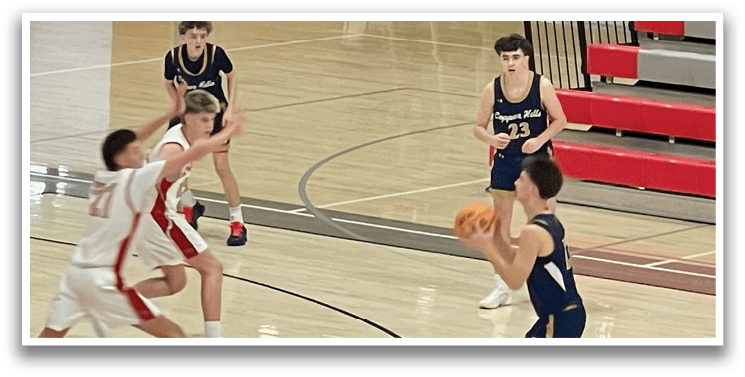 A group of young men playing basketball on a court. AI generated content