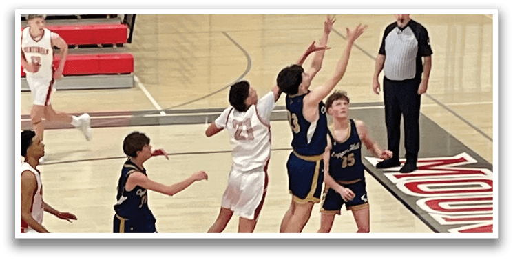 A group of young men playing basketball on a court. One player is jumping to block a shot. AI generated content