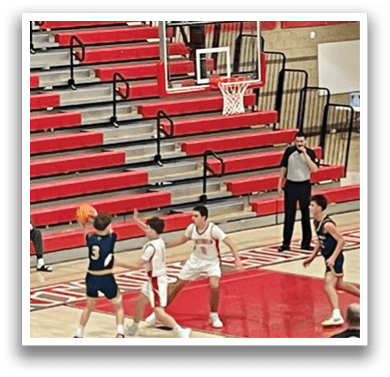 A group of young men playing basketball on a court. AI generated content