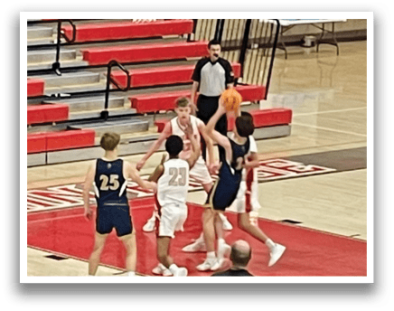 A group of young men playing basketball on a court. AI generated content