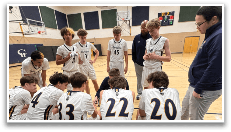 A group of young men are sitting on a bench in a gym, wearing basketball uniforms. AI generated content