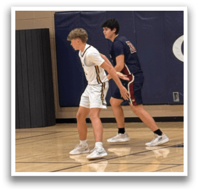 Two basketball players on a court, one with a white shirt and the other with a blue shirt. AI generated content
