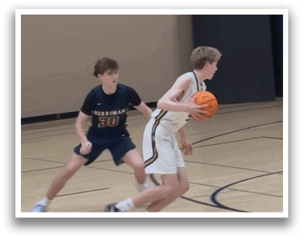 Two boys playing basketball on a court. One boy is holding a basketball while the other is running towards him. AI generated content