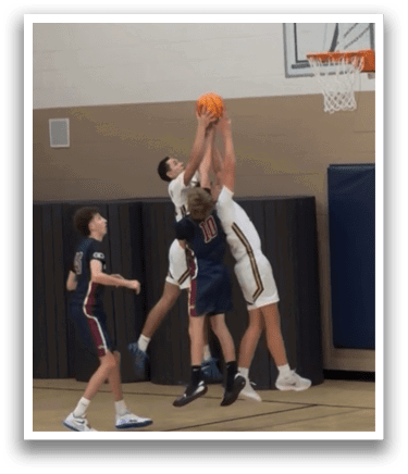 A basketball game is in progress with two players fighting for the ball. AI generated content