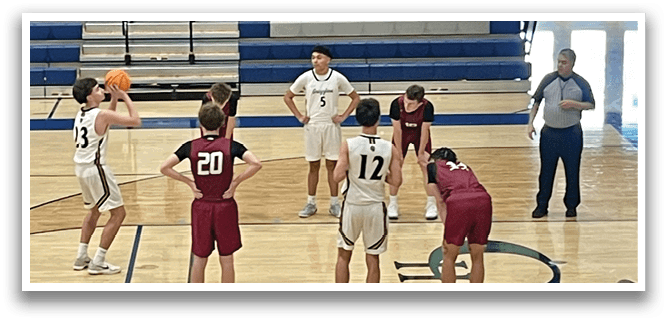 A group of young men playing basketball on a court. AI generated content