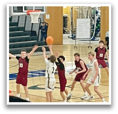 A group of young men playing basketball on a court. AI generated content