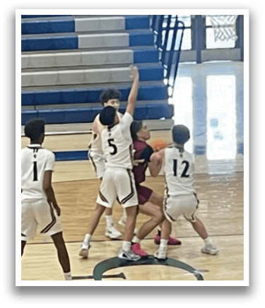 A group of young men playing basketball on a court. AI generated content