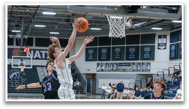 Two basketball players jumping for the ball in a game. AI generated content