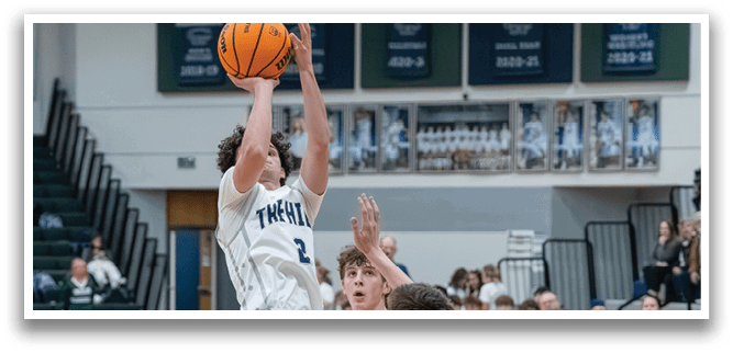 Two basketball players are fighting for the ball, with one player jumping in the air to grab it. AI generated content
