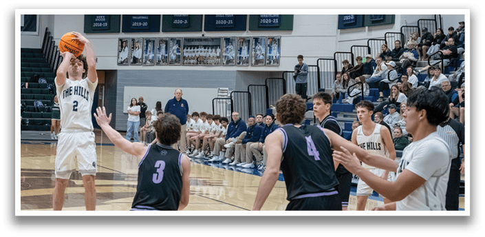 A basketball game is in progress with a player in the air attempting to score a basket. AI generated content