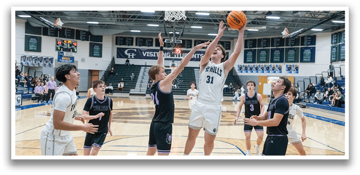 A group of men playing basketball on a court. One player is jumping to block a shot. AI generated content