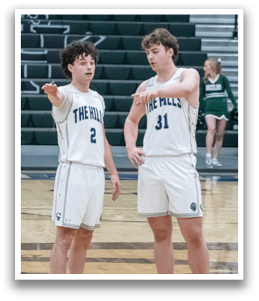 Two basketball players on a court, one pointing at the other. AI generated content