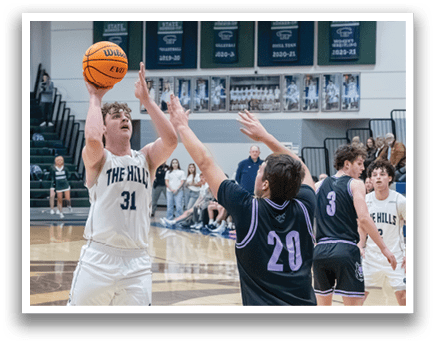 Basketball players on a court, one with a basketball in his hands, the other trying to block him. AI generated content