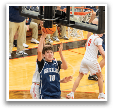 A basketball player wearing a blue jersey with the number 10 is attempting to dunk the ball. AI generated content
