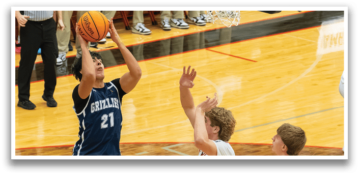A basketball player is attempting to score a basket while being guarded by another player. AI generated content