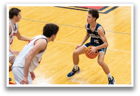 Three men playing basketball on a court. One man is holding a basketball, while two others are trying to block him. AI generated content